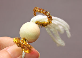 Easy Angel Crafts Tulle Angel step 8 push the yarn through the newly made circle