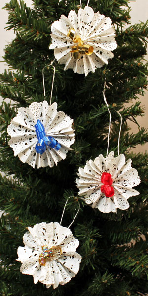Easy Christmas Crafts Paper Doily Flower Ornament with four finished hanging on tree