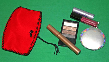 Easy felt crafts cosmetic pouch with cosmetics beside it