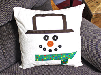 Fred the Snowman Pillow finished on couch to the right