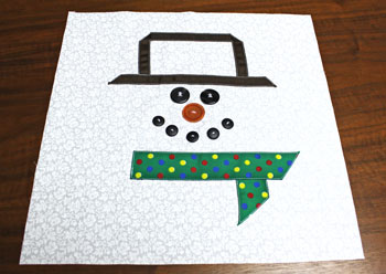 Fred the Snowman Pillow step 7 sew buttons