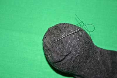 Frugal-Fun-Crafts-Mending-Socks-with-light-bulbs-trouser-sock-hole-with-bulb-knot-thread