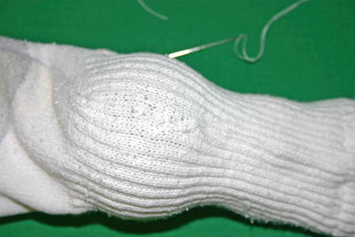 Frugal-Fun-Crafts-Mending-Socks-with-light-bulbs-white-sock-back-hole-finished
