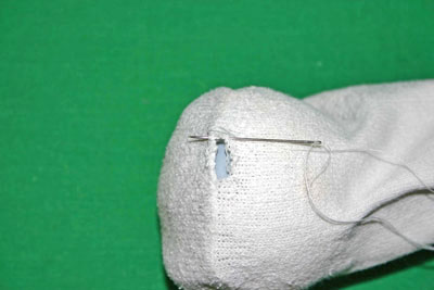 Sock mending with a light bulb