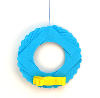 Eight Squares Wreath Ornament blue with yellow bow on display