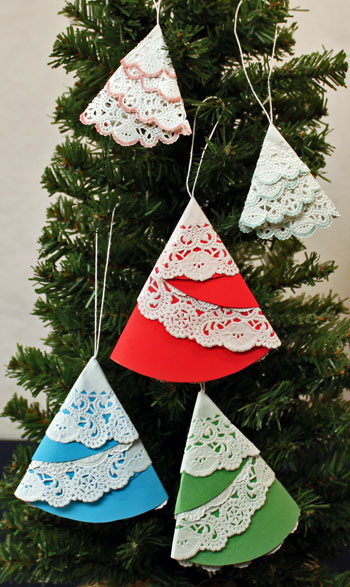 Easy Christmas Crafts Paper Doily Folded Christmas Tree Ornament five finshed ornaments hanging on the tree