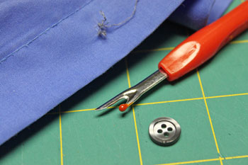 How to sew on a button step 2 shows the loose threads