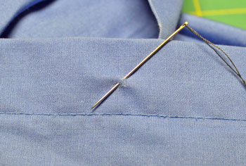 How to sew on a button step 5 first stitch to hide the knot