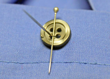 How to sew on a button step 7 place pin across button