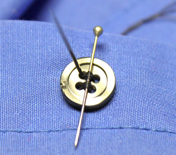 How to sew on a button step 8 stitch over pin