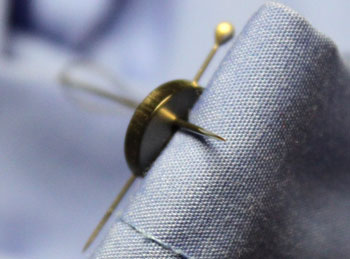 How to sew on a button step 9 push needle under button