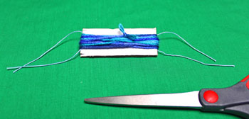 Yarn Elf Ornament step 10 tie large yarn ends together